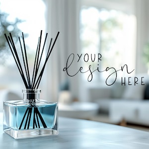 May include: A clear glass diffuser bottle with black reeds, filled with blue liquid. The bottle is sitting on a white table with a blurred background of a living room.