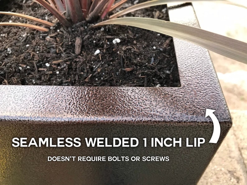 May include: A close-up of a brown metal planter with a 1-inch lip. The lip is seamless and welded, so it doesn't require bolts or screws. The planter is filled with soil and a plant.
