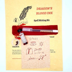 May include: A spell writing kit with a small bottle of red ink labeled "Dragon's Blood Ink", a quill pen, and a piece of parchment paper with the words "Spells" and "Danty 3-13-21" written in red ink.