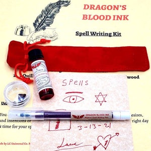 May include: Dragon's Blood Ink Spell Writing Kit with a red velvet pouch, a small bottle of ink, a quill pen, and a piece of obsidian. The kit also includes a sheet of paper with various symbols and the text "Spells" written on it. The pen is labeled "Dragon Blood Ink Magical Spell Writing Pen" and the date "3-13-21" is written on the paper.