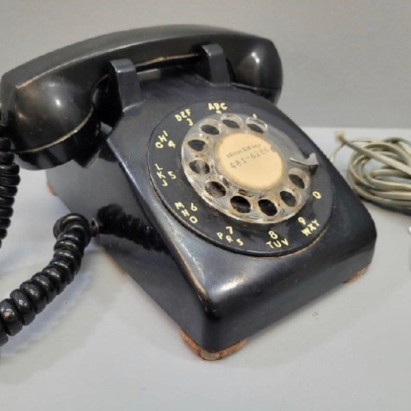 Vintage black rotary telephone in working order.