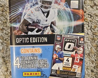 May include: A rectangular metal tin featuring Tyreek Hill. The tin is labelled "Optic Edition" and contains 4 Panini Donruss Optic football packs. The packaging also displays the NFLPA logo.
