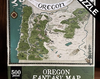May include: A 500-piece puzzle featuring a fantasy map of Oregon. The map is illustrated with green and brown tones, depicting mountains, forests, and rivers. The puzzle box has the text "Oregon Fantasy Map" and "Puzzle" in a diagonal banner.