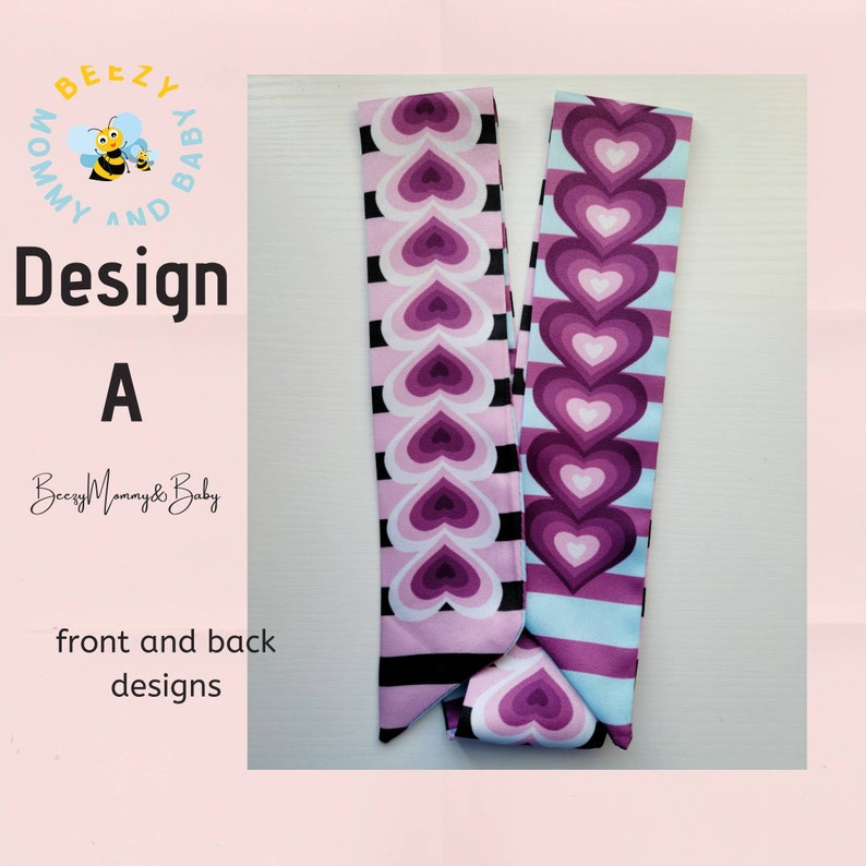 May include: A pink and purple fabric headband with a repeating pattern of hearts. The headband has a black and white striped pattern on one side and a light blue and white striped pattern on the other side. The text "Design A" is visible in the image.
