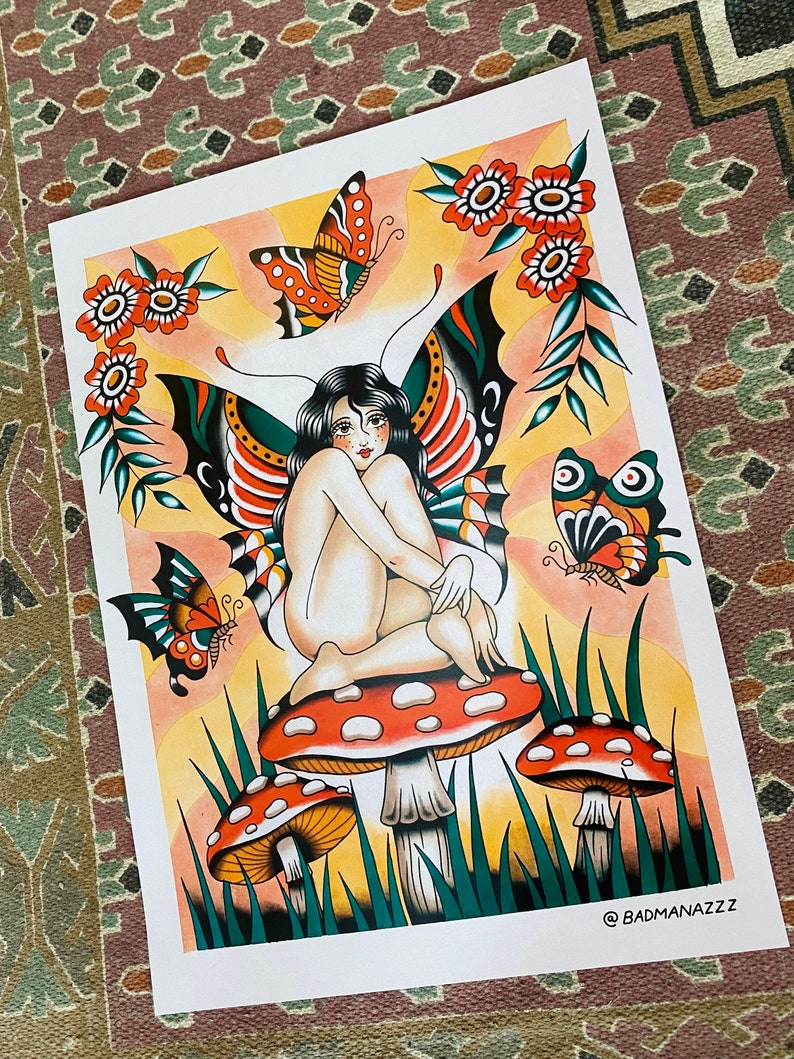 May include: A colorful illustration of a fairy sitting on a mushroom with butterfly wings. The fairy is nude and has long black hair. The mushroom is red with white spots and is surrounded by green grass. There are three butterflies in the image, one on each side of the fairy and one above her head. The background is a yellow-orange color with a sunburst effect.