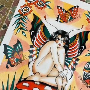 May include: A colorful illustration of a fairy with butterfly wings sitting on a red and white mushroom. The fairy has long black hair and is wearing a green and red butterfly wing costume. There are other butterflies and flowers in the background.