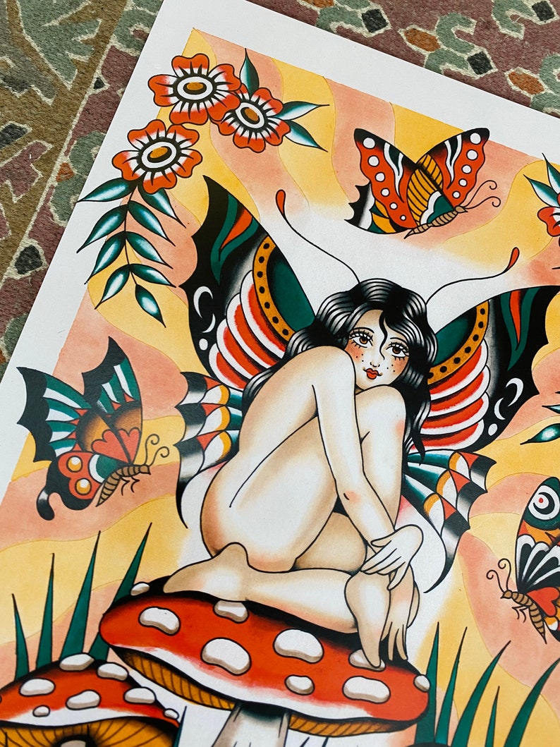 May include: A colorful illustration of a fairy with butterfly wings sitting on a red and white mushroom. The fairy has long black hair and is wearing a green and red butterfly wing costume. There are other butterflies and flowers in the background.