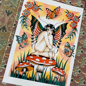 May include: A colorful illustration of a fairy with butterfly wings sitting on a mushroom. The fairy has long black hair and is wearing a red and green butterfly wing costume. The background is a yellow and orange gradient with green leaves and red flowers.
