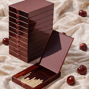 May include: A set of three ceramic mugs with a speckled, matte finish. Each mug features a different color: light blue, cream, and gray. The mugs have a simple, modern design and a comfortable handle.