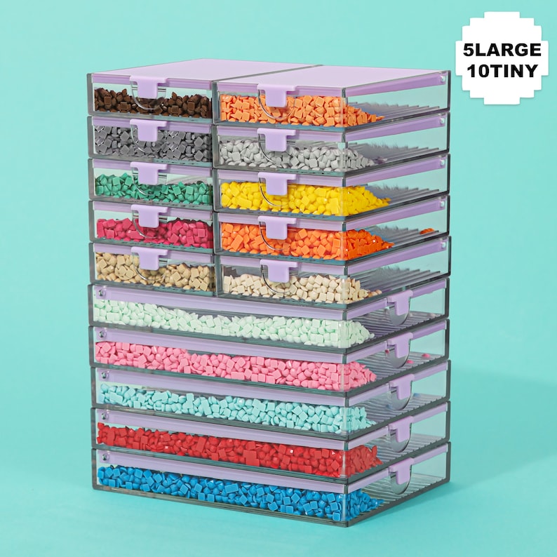 May include: A stack of clear plastic storage containers with lavender lids and latches, filled with colorful craft beads. The text "5 LARGE 10 TINY" is in the upper right corner. The beads are various colors, including brown, orange, gray, green, pink, and blue.