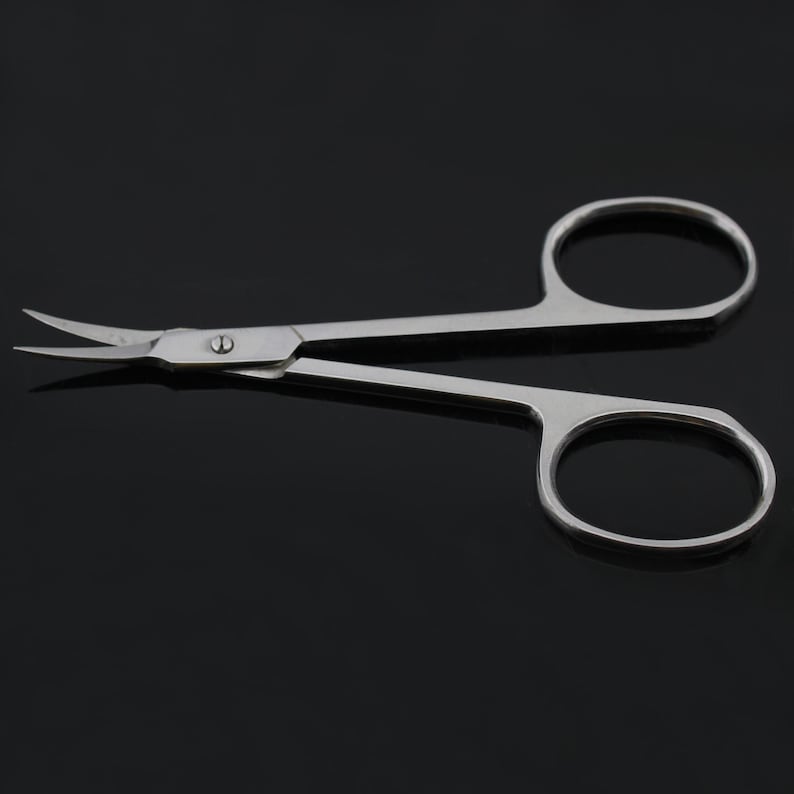 May include: A pair of stainless steel curved tweezers with a silver finish. The tweezers have a sharp point and are designed for precision work.