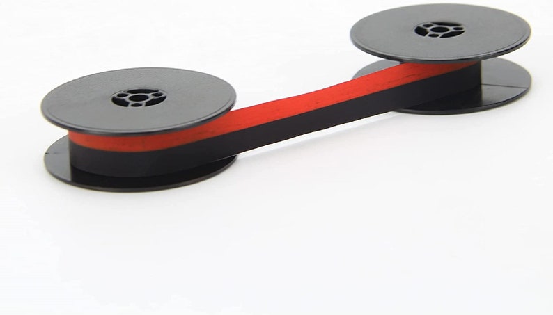 May include: A black and red typewriter ribbon spool with two black plastic spools.