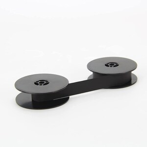 May include: Black typewriter ribbon spool with two black plastic spools connected by a black ribbon.