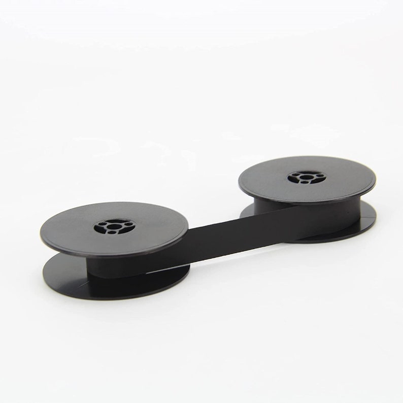 May include: Black typewriter ribbon spool with two black plastic spools connected by a black ribbon.
