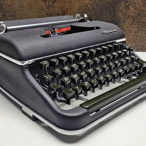 Olympia SM3 Black Vintage Typewriter: Mid-Century Collectible