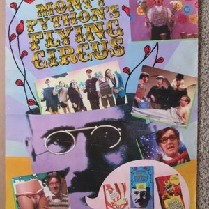 May include: Poster for Monty Python's Flying Circus, a BBC television series. The poster features a collage of images, including the show's title in gold lettering, portraits of the cast, and VHS tapes. The price is $24.95.