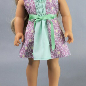 This 18 inch doll Shirred Front Dress PDF Sewing pattern is styled from the 1970s. This dress has a center front panel with shirring in the bodice extends to the skirt. There are two options for shirring in the center front panel. You may sew gathers and then apply a ⅛ to ¼ inch ribbon or gather the front section with elastic for a smocked effect. There are two sleeve options for the dress: a puff sleeve option or sleeveless. The neckline on dress is square and the skirt is semi-full.