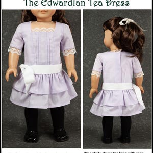 May include: A lavender doll dress with a white sash and lace trim. The dress has a tiered skirt and short sleeves. The front of the dress is shown on the left, and the back with a snap closure is shown on the right. The text reads "The Edwardian Tea Dress."