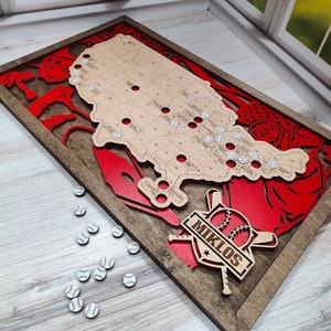 May include: A wooden map of the United States with baseballs in each state. The map is framed in a dark wood frame with a red baseball theme. The name "Miklos" is displayed on the bottom of the frame.