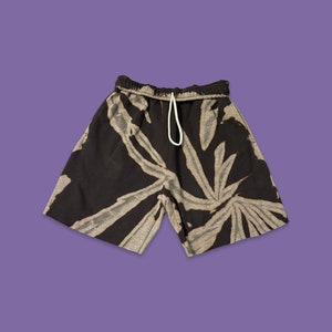 May include: Black and white tie-dye shorts with a drawstring waist.