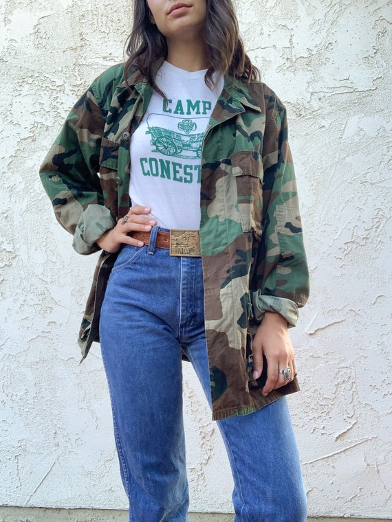 camo jacket with blue jeans