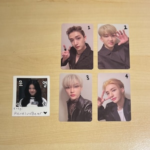 May include: Four photo cards featuring different people. The cards are numbered 1 through 4. The first card shows a person with brown hair wearing a black jacket. The second card shows a person with brown hair wearing a black jacket. The third card shows a person with blonde hair wearing a black jacket. The fourth card shows a person with blonde hair wearing a black jacket. The cards are all set against a light brown background.