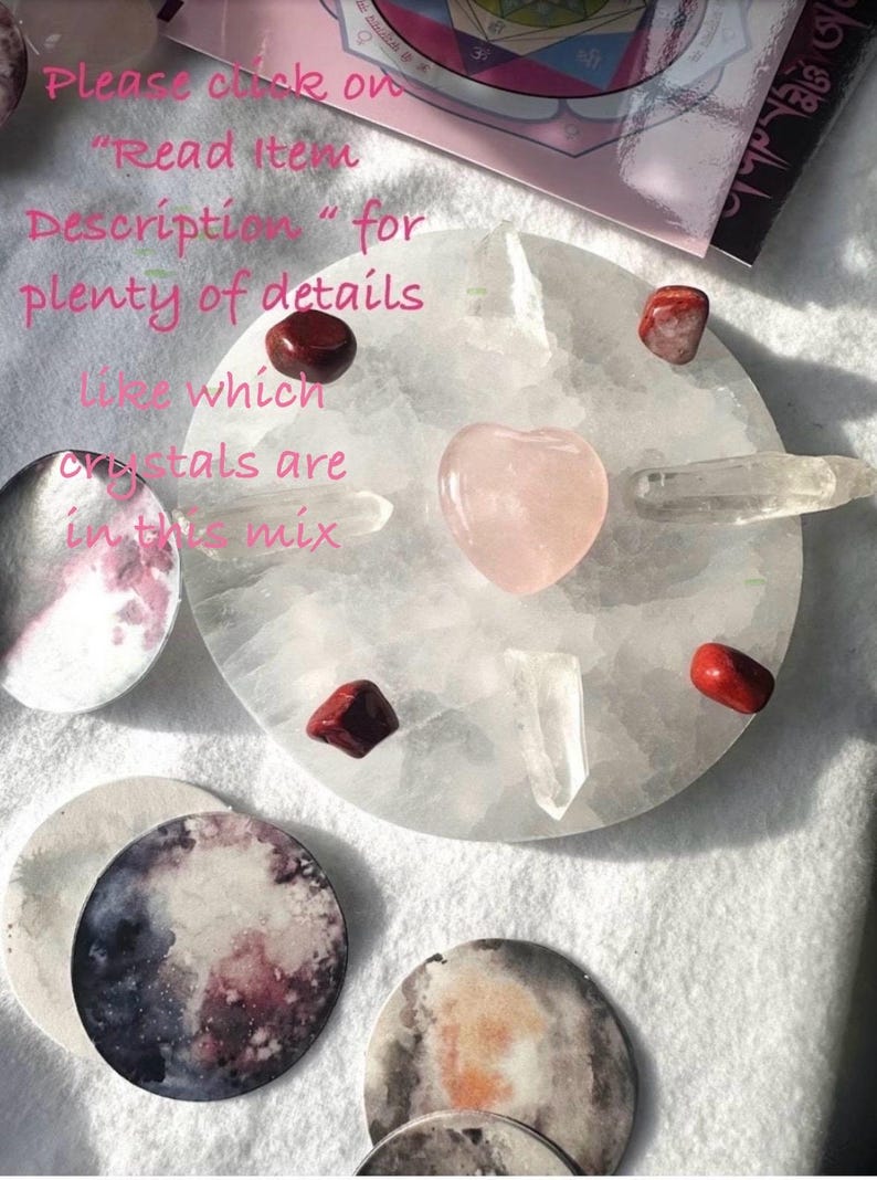 May include: A white, round selenite charging plate with a pink heart-shaped crystal, red and clear crystals, and moon-themed coasters. The image includes text that reads "Please click on 'Read Item Description' for plenty of details like which crystals are in this mix."