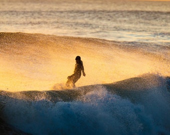 Surfer in cold water wetsuit swirl with sunrise colors