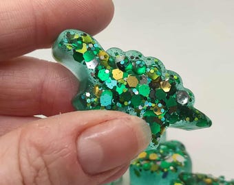 Pocket pal dino. Pocket pet. Glow in the dark. Pocket dino. Dinosaur. Resin dinosaur. Dinosaur fidget toy.