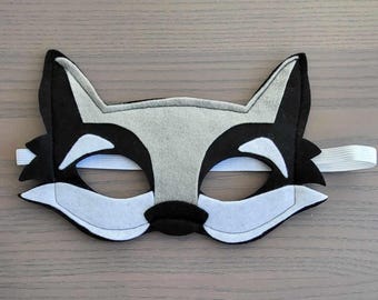 May include: A grey and black felt raccoon mask with white eye holes and an elastic band.