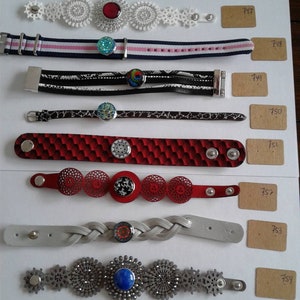 May include: A collection of ten bracelets with different designs and colors. Each bracelet features a unique charm with a colorful glass cabochon. The bracelets are numbered 746 through 754.