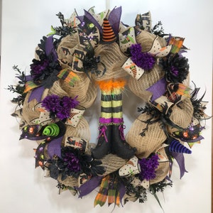 Halloween poly jute mesh wreath for front door with witch legs and hats, purple dahlias and black foliage, family friendly witch theme decor