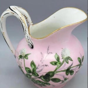 A French 1882 “Lamoges” antique hand painted procelain creamer pitcher.