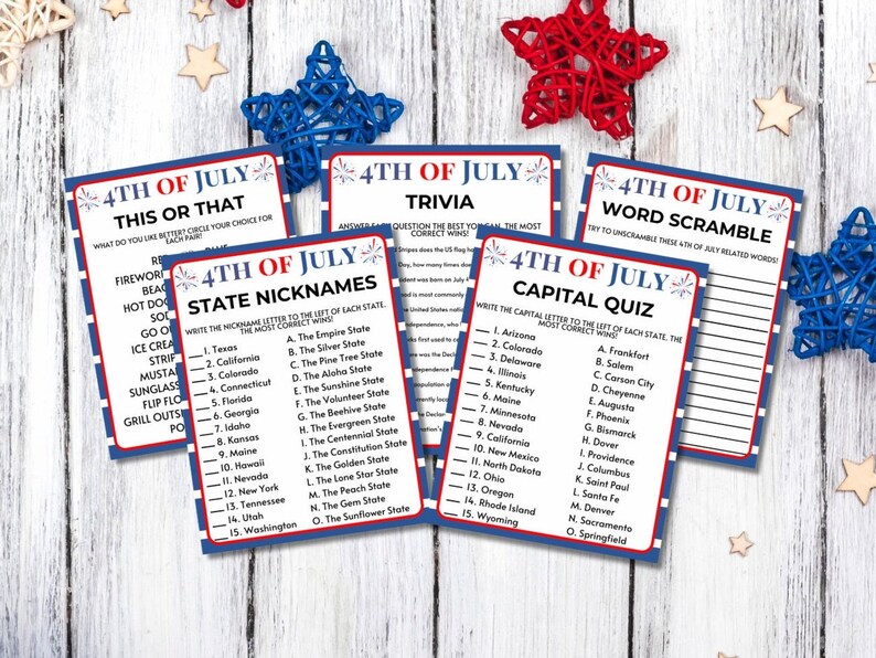 May include: A collection of 4th of July trivia game cards with red, white, and blue borders. The cards feature various quiz formats, including "This or That," "Trivia," "State Nicknames," "Capital Quiz," and "Word Scramble." Decorative star accents are scattered around.