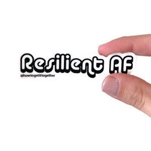 May include: White sticker with black text that reads "Resilient AF" with the hashtag "@howtogetittogether" below.