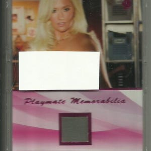 May include: A pink and white trading card with a photo of a woman with blonde hair. The card has the text "Playmate Memorabilia" and "Amy Leigh Andrews".