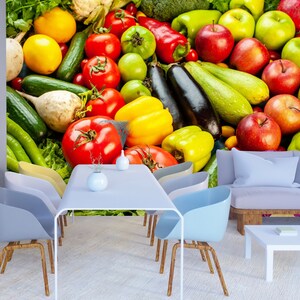 May include: A colorful still life featuring a variety of fresh produce, including red tomatoes, green peppers, yellow lemons, and red apples. The produce is arranged in a visually appealing way, creating a vibrant and appetizing display.
