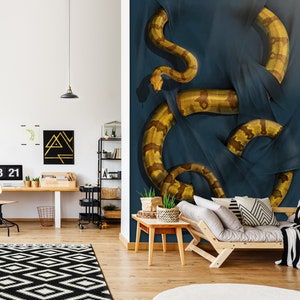 Könnte beinhalten: Eine große, gelbe und braune Schlange ist um einen dunkelblauen Stoff gewickelt. Der Kopf der Schlange ist oben im Bild sichtbar, der Schwanz unten. Der Stoff ist über die Schlange gelegt und erzeugt so ein Gefühl von Bewegung und Spannung.