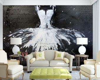 May include: A white tutu with black paint splatters on a black and white background with handwritten text. The tutu is in a living room setting with a couch, two end tables, and a coffee table.