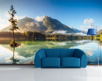May include: A scenic landscape mural depicting a lake with a solitary tree on a small island in the foreground. The lake is surrounded by verdant trees and mountains in the background. The sky is a bright blue with white clouds.