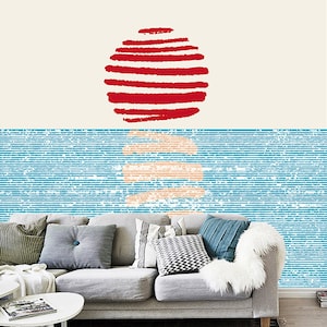 May include: A gray couch with pillows in a living room setting. The wall behind the couch has a blue and white striped pattern with a red circle design at the top.