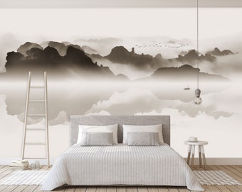 May include: A white bed with a white duvet cover and two white pillows. The bed is in front of a wall with a black and white abstract painting of mountains and clouds.
