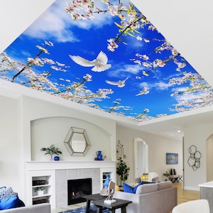 May include: A white ceiling mural depicting a blue sky, white clouds, and white doves flying amongst pink cherry blossoms.