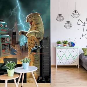 May include: A blue robot toy stands in front of a giant cat monster in a city setting. The cat is roaring with its mouth open and has a helicopter flying in front of it. The background is a dark stormy sky with lightning.