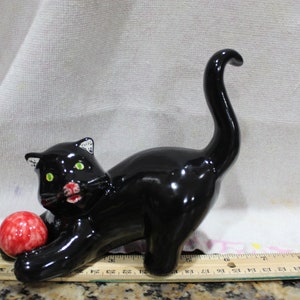 Black Cat with Red Ball green eyes