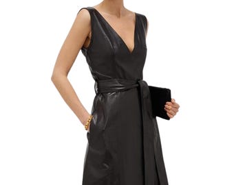 May include: A black leather dress with a V-neckline and a belt. The dress has a fitted bodice and a flowing skirt.