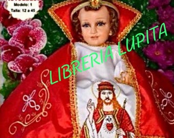 May include: A red and gold embroidered robe with a white lining. The robe features a small image of a man with a crown and a heart. The text "NINO CRISTO REY" is at the top of the image. The text "Novedades Modelo: 1 Talla: 12 a 45" is in the top left corner. The text "LIBRERIA LUPITA" is in the bottom right corner.