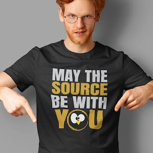 May include: A black t-shirt with a gold and white graphic that says "May the source be with you" with a cartoon eye and beak design.