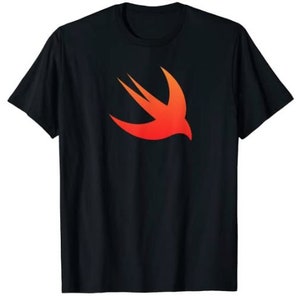 May include: Black t-shirt featuring a vibrant orange and red graphic of a stylized bird in flight. The design is centered on the chest of the shirt. The t-shirt has short sleeves and a crew neck.