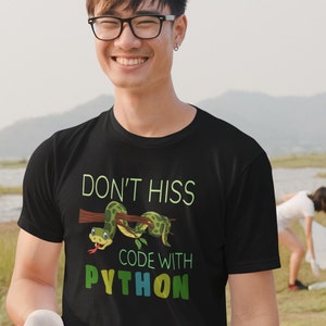 May include: Black t-shirt featuring a green snake graphic and the text "Don't hiss code with Python".